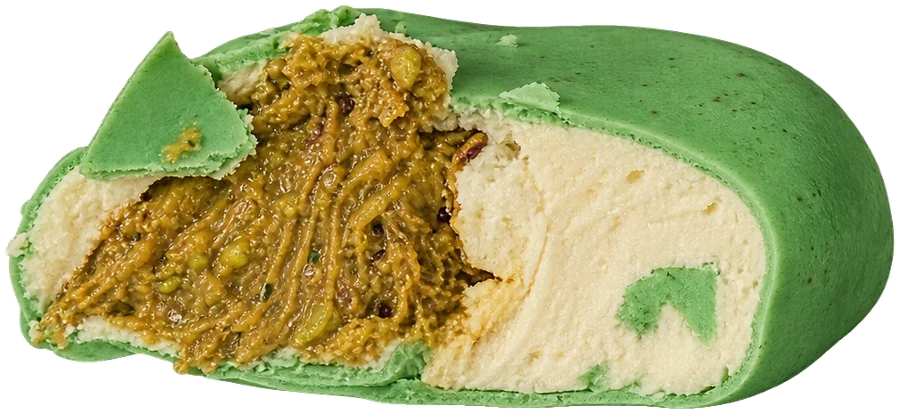 Green pistachio dessert cut open on its pistachio filling